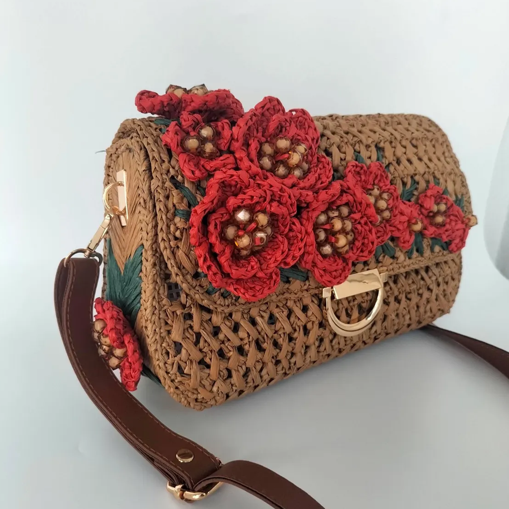 Warm Tan Open Grid Woven Straw Rectangular Satchel With Hand Crochet Red Floral Flap Embellishment, Polished Golden D-Ring Clasp And Fixed Brown Trim Shoulder Strap Hardware