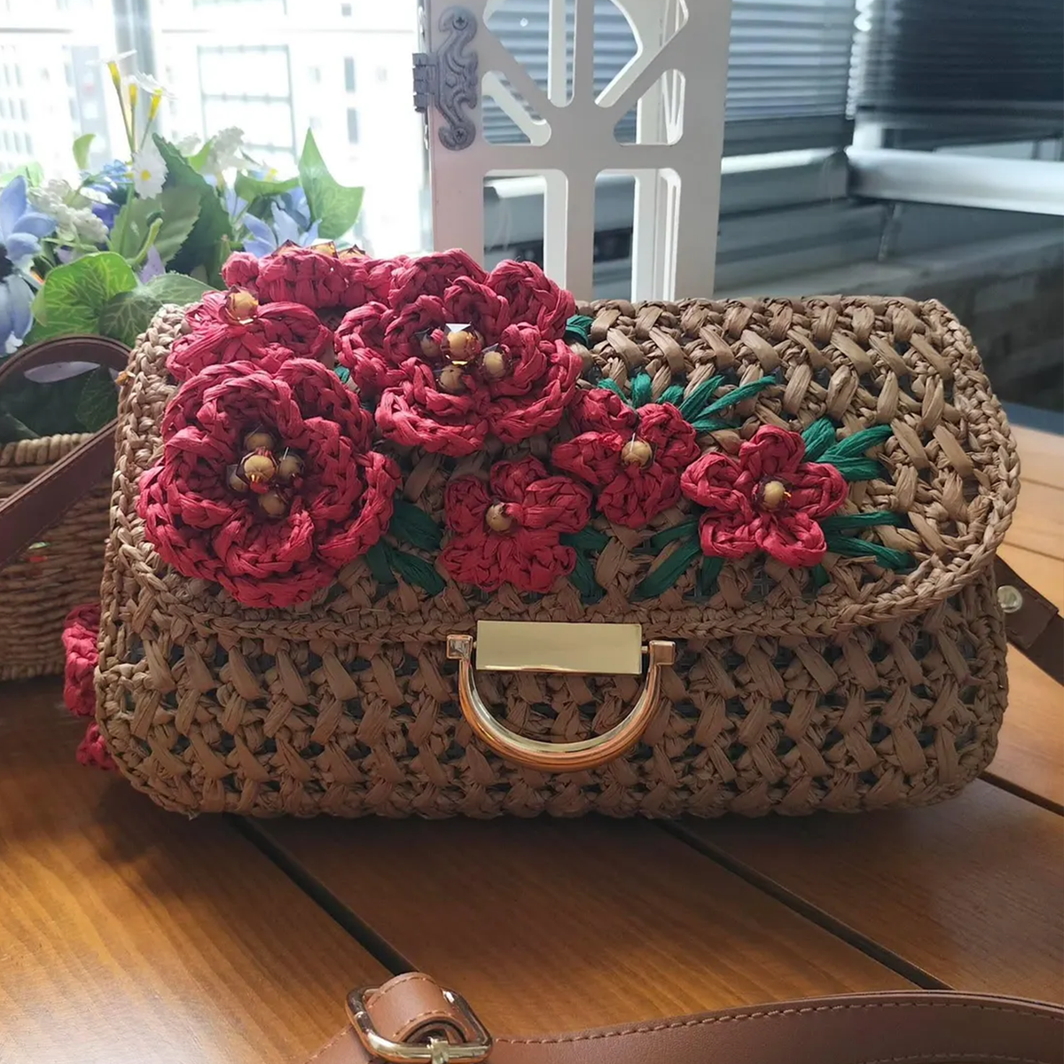 Warm Tan Open Grid Woven Straw Rectangular Satchel With Hand Crochet Red Floral Flap Embellishment, Polished Golden D-Ring Clasp And Fixed Brown Trim Shoulder Strap Hardware