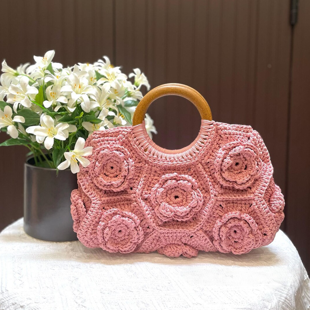 Pastel Blush Pink Hand-Crocheted Floral Handheld Pouch With 3D Rose Patchwork Motifs, Solid Polished Wooden Ring Top Grip And Scalloped Wide Rectangular Silhouette