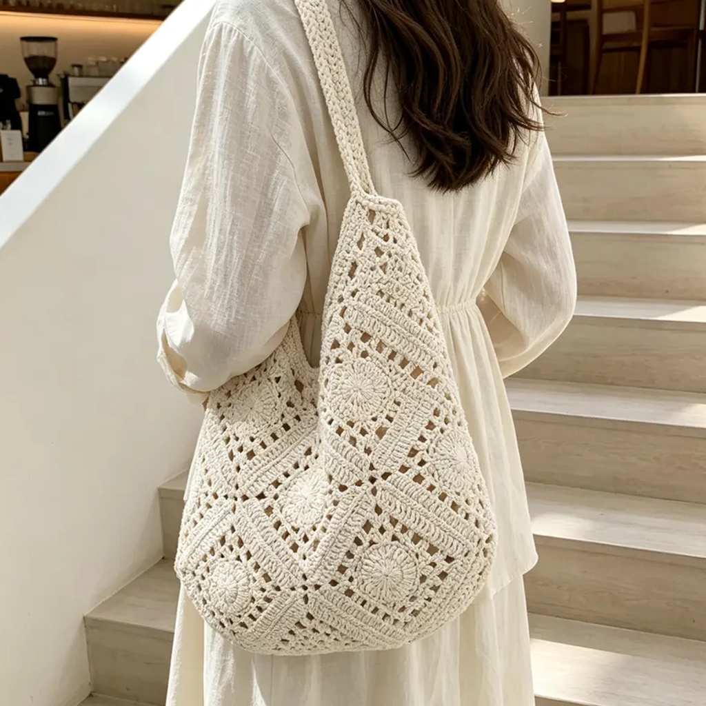 Cream Openwork Granny Square Crochet Slouch Crescent Shoulder Tote With Integrated Continuous Woven Loop Strap And Floral Rosette Panel Detailing
