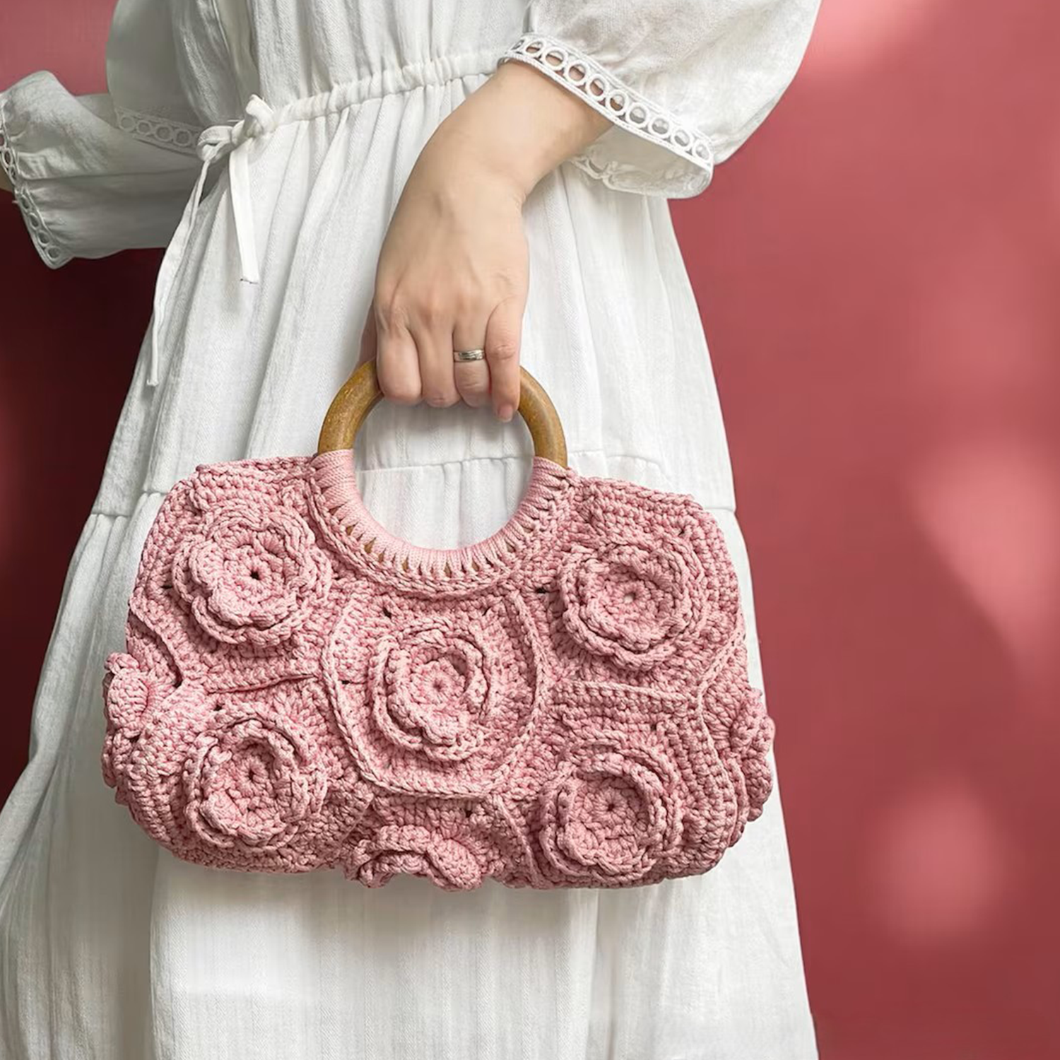 Pastel Blush Pink Hand-Crocheted Floral Handheld Pouch With 3D Rose Patchwork Motifs, Solid Polished Wooden Ring Top Grip And Scalloped Wide Rectangular Silhouette