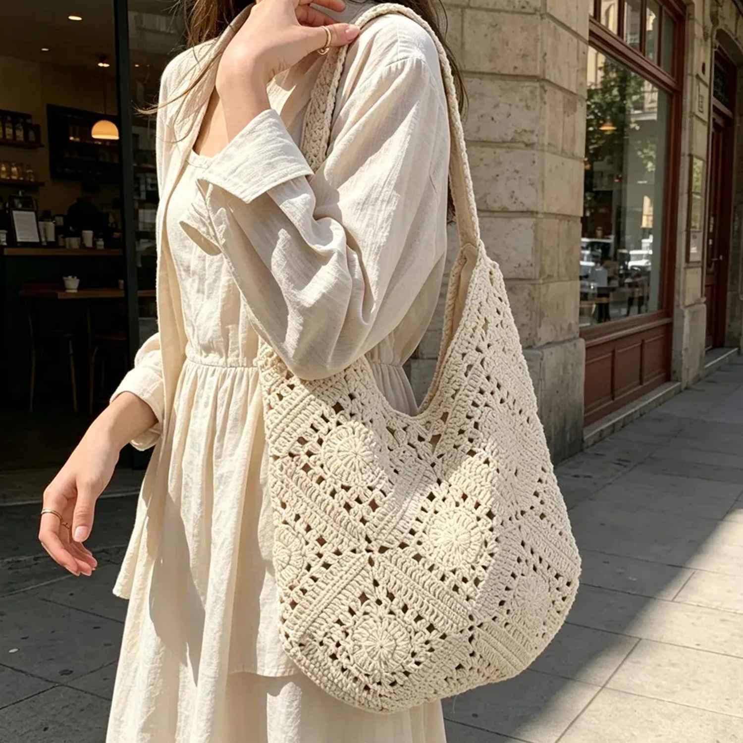 Cream Openwork Granny Square Crochet Slouch Crescent Shoulder Tote With Integrated Continuous Woven Loop Strap And Floral Rosette Panel Detailing