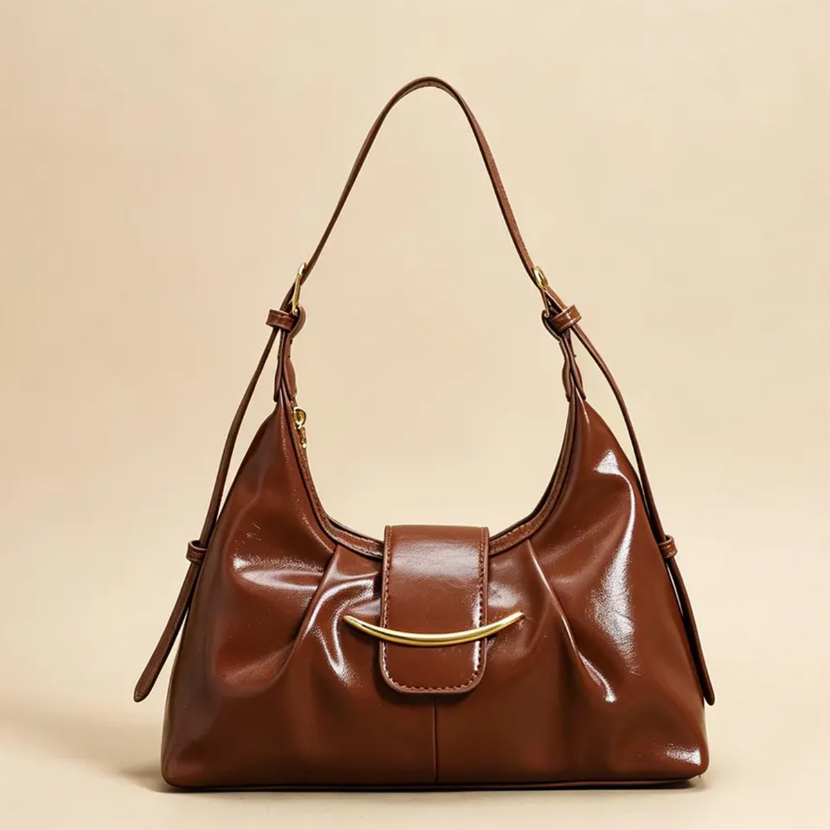 High-Gloss Gathered Pleat Crescent Underarm Bag With Curved Gold Bar Flap Accent, Slider Fitted Shoulder Strap And Secure Curved Top Zip Closure Hardware Leather Bag