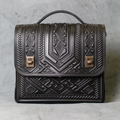 Deep Black Embossed Tribal Geometric Structured Rectangular Satchel With Curved Fixed Top Handle, Punch-Hole Shoulder Strap And Dual Antique Brass Turn-Lock Flap Fastener Hardware Leather Bag