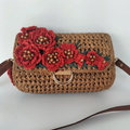 Warm Tan Open Grid Woven Straw Rectangular Satchel With Hand Crochet Red Floral Flap Embellishment, Polished Golden D-Ring Clasp And Fixed Brown Trim Shoulder Strap Hardware