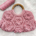 Pastel Blush Pink Hand-Crocheted Floral Handheld Pouch With 3D Rose Patchwork Motifs, Solid Polished Wooden Ring Top Grip And Scalloped Wide Rectangular Silhouette