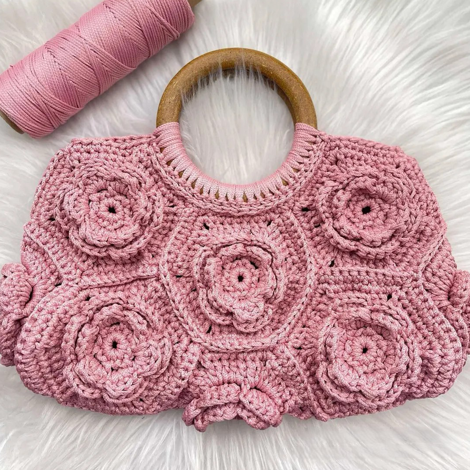 Pastel Blush Pink Hand-Crocheted Floral Handheld Pouch With 3D Rose Patchwork Motifs, Solid Polished Wooden Ring Top Grip And Scalloped Wide Rectangular Silhouette